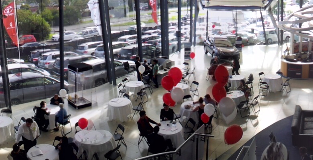Ultimate Events - Dealership event with guests and balloons in showroom
